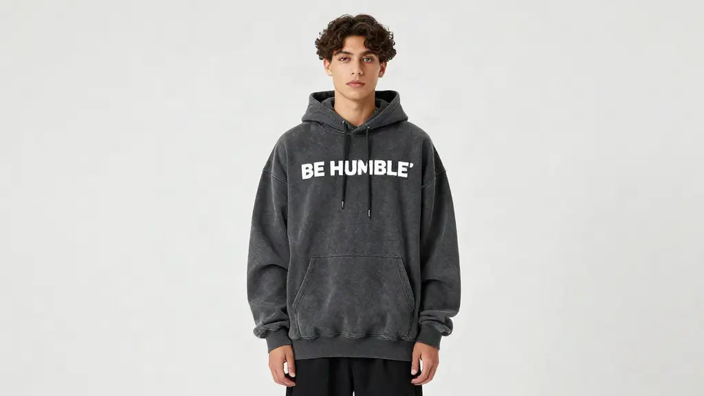 Model wearing an oversized charcoal Be Humble hoodie